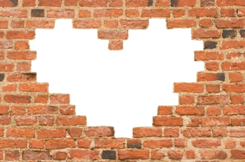 Heart shaped hole in old brick wall